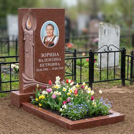 Мемориал с горящей свечой из красного гранита